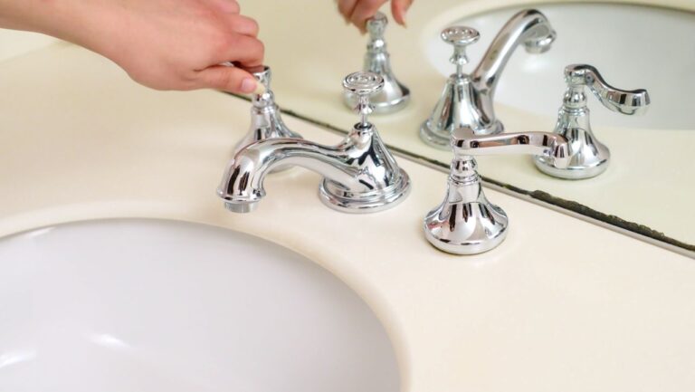 The Art of Drawing Readers In: Your attractive post title goes here Close-up of a hand adjusting a chrome faucet in a modern bathroom interior.